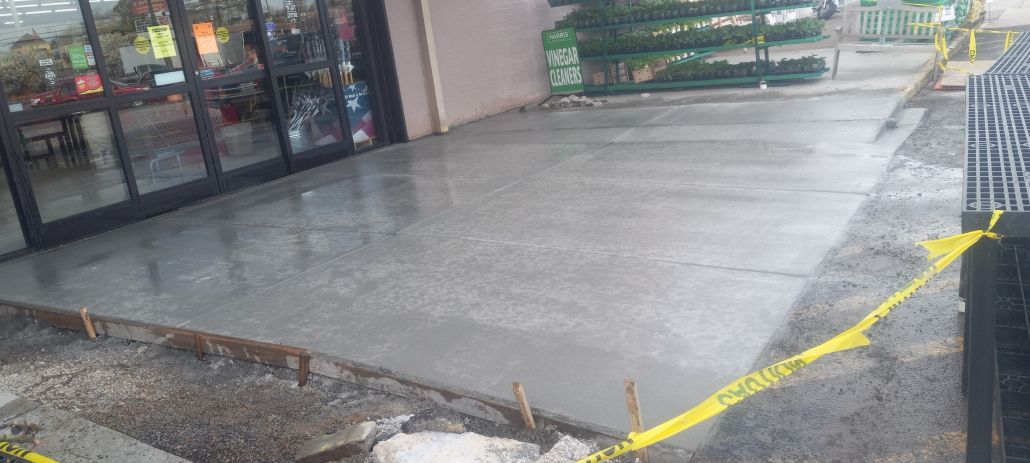 A concrete patio is being built in front of a building.