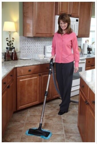 Woman Vacuum Cleaning the Kitchen — Baldwin, MD — JPI Services