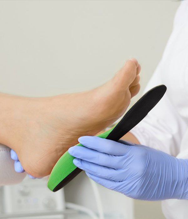 Woman Rubbing Sore Feet — Orthotics in Urunga, NSW