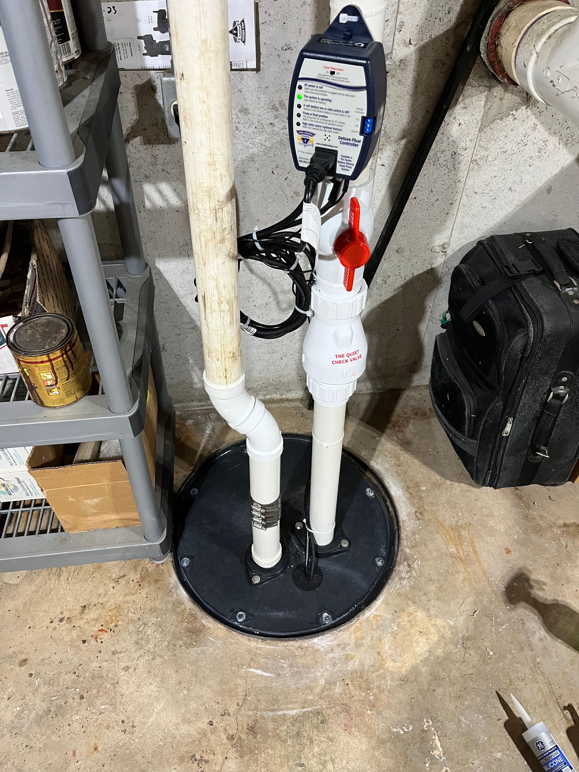 A close up of a sump pump in a basement.