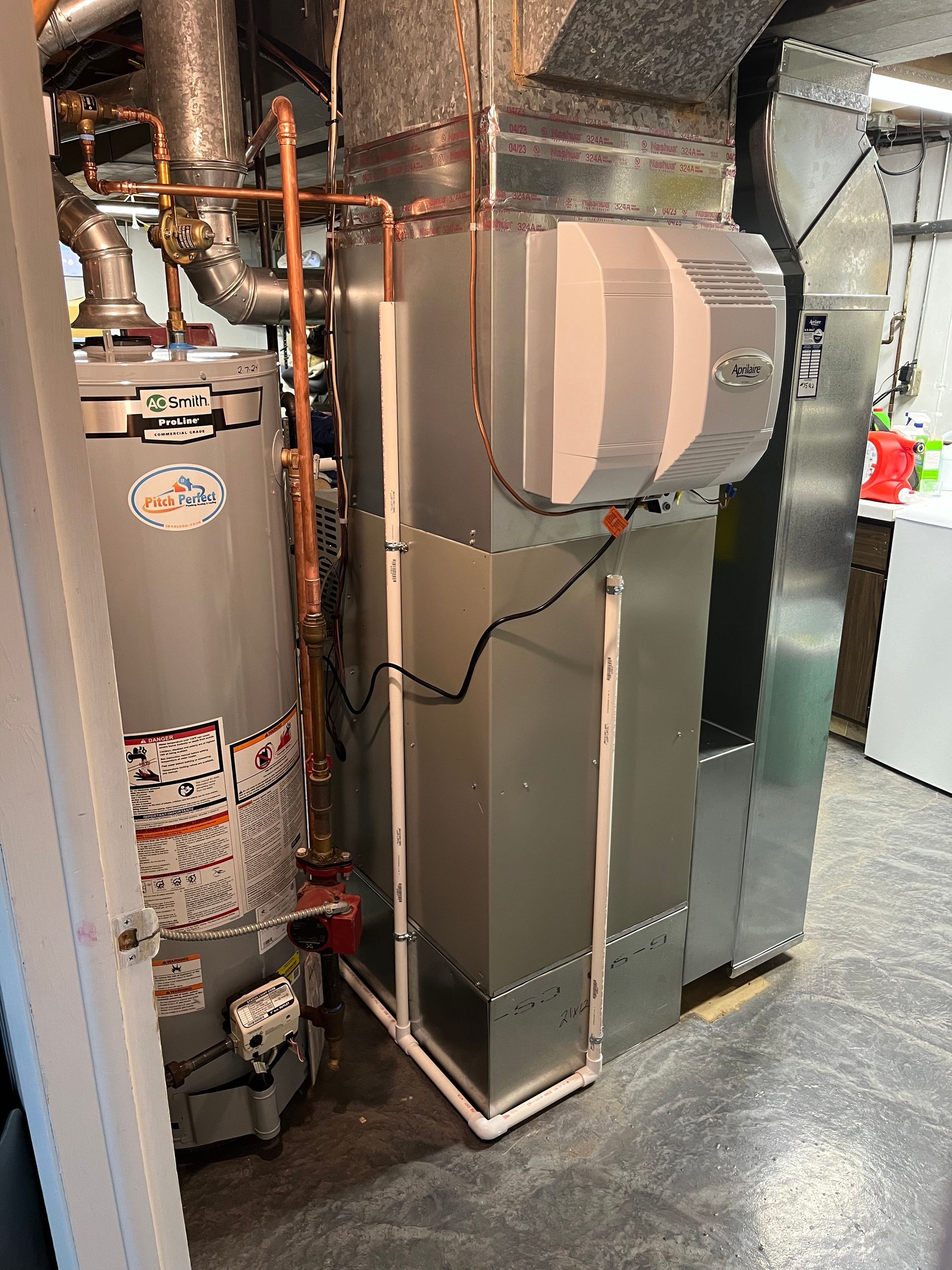 There is a water heater and an air conditioner in the basement.