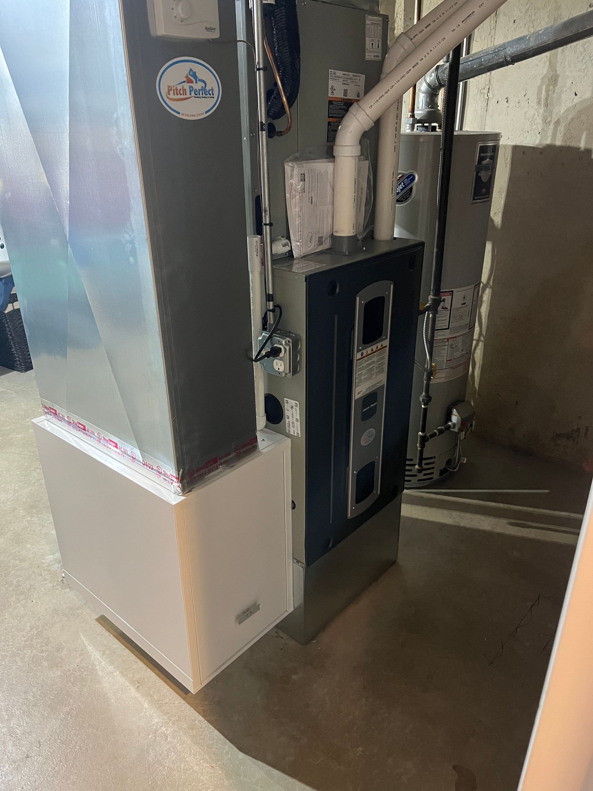 A picture of a heating and cooling system in a basement.