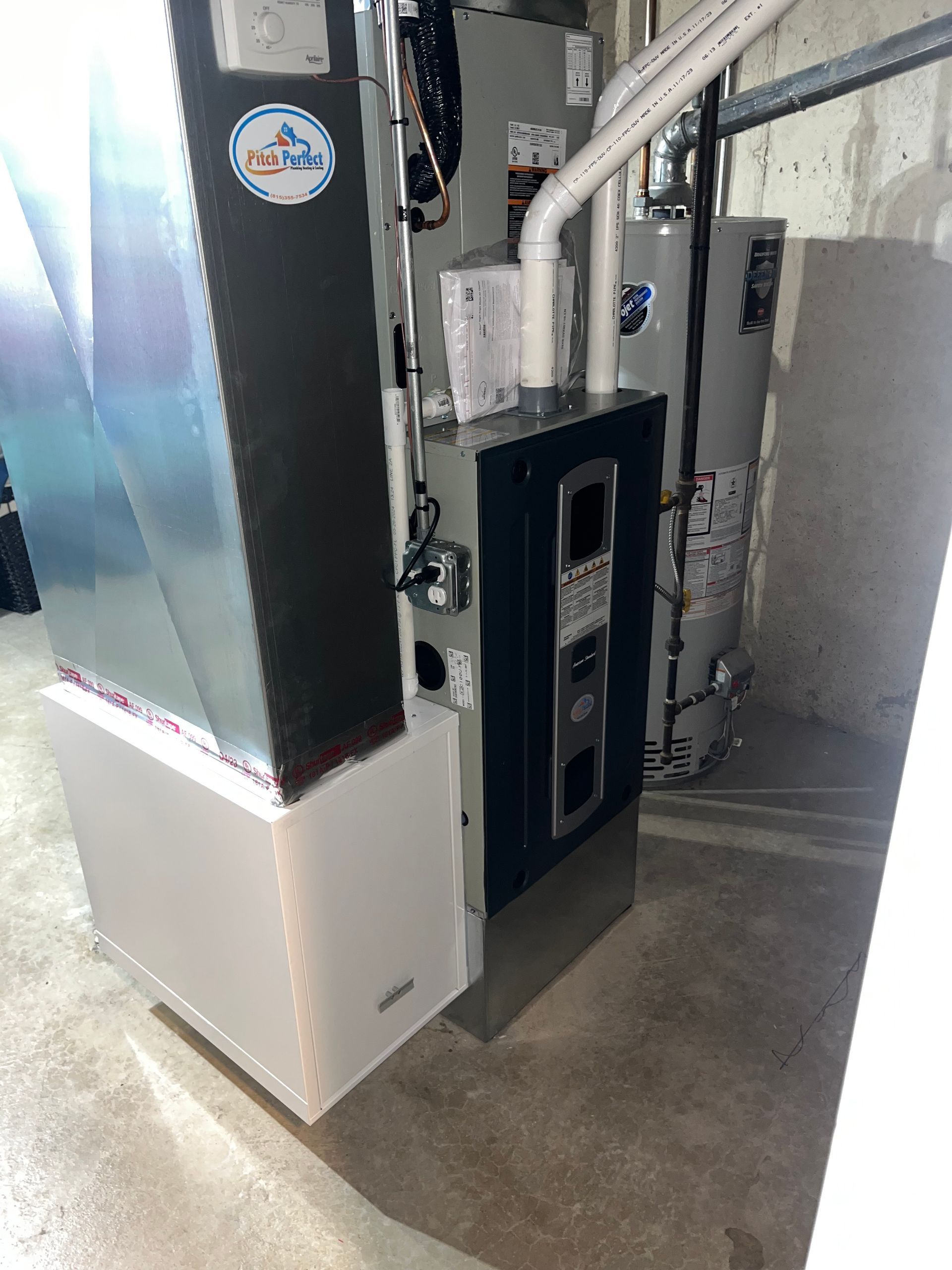 A picture of a heating and cooling system in a basement.