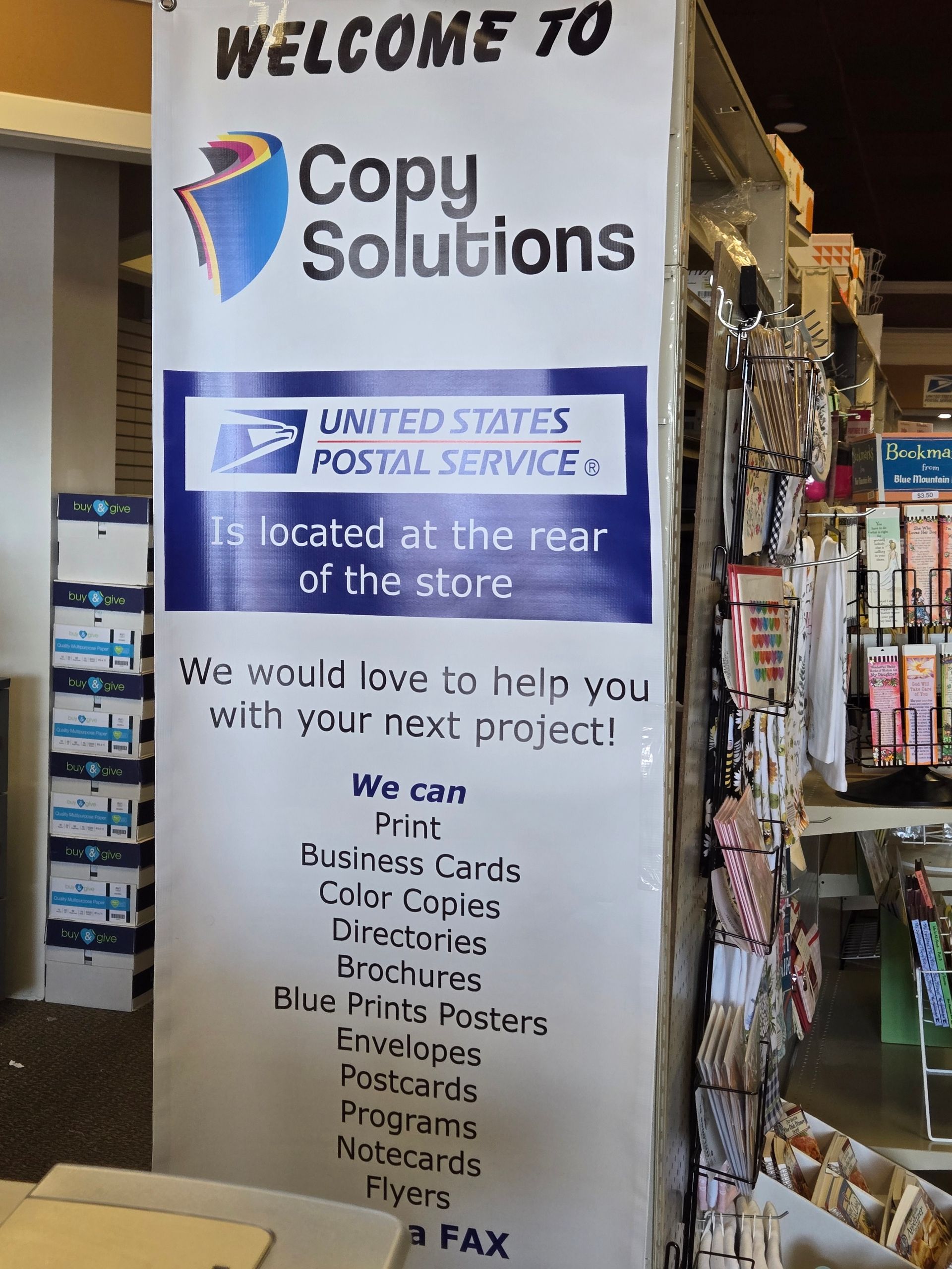 A sign in a store that says welcome to Copy Solutions