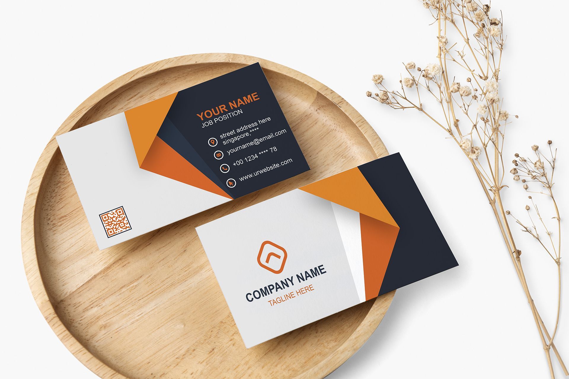 Two business cards are sitting on top of a wooden tray.