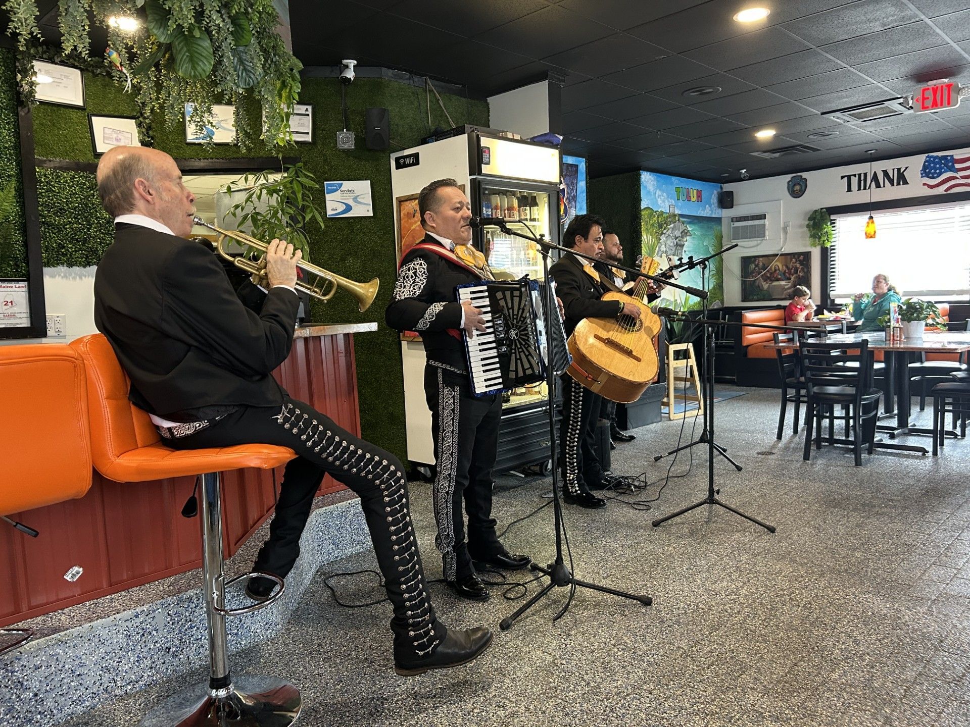 A group of men are playing instruments in a restaurant.
