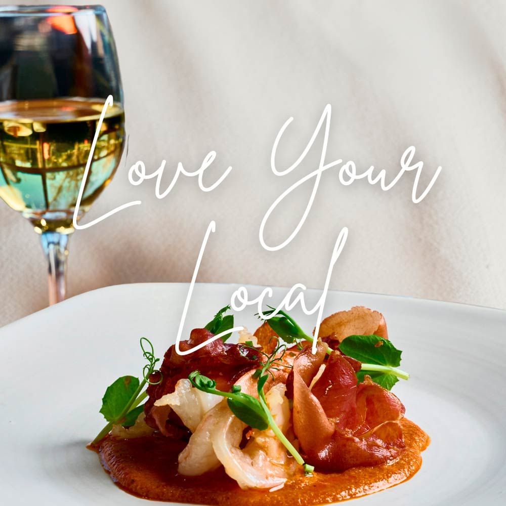 Dish of food on white plate with glass of wine, 