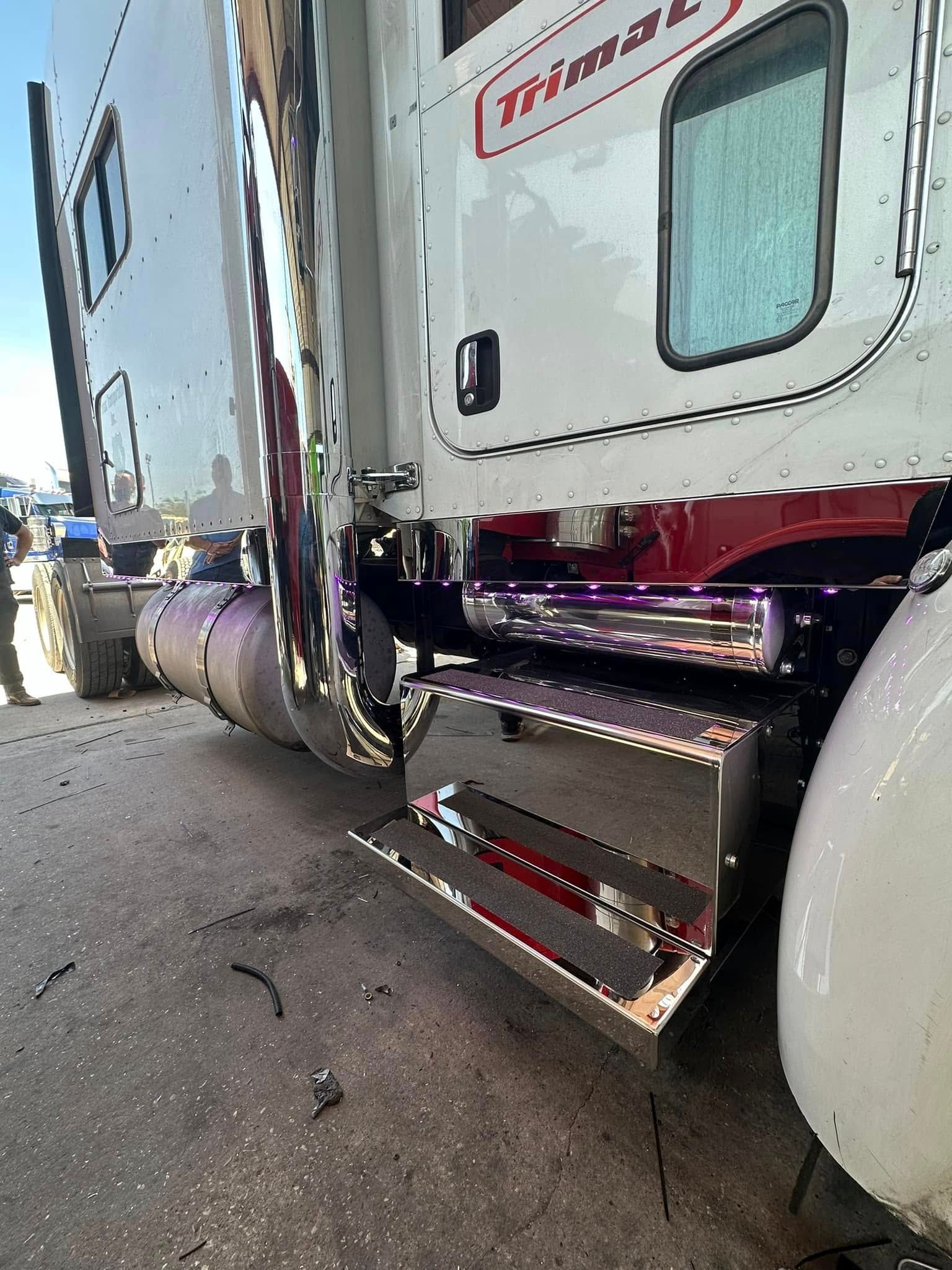 A semi truck is parked on the side of the road.