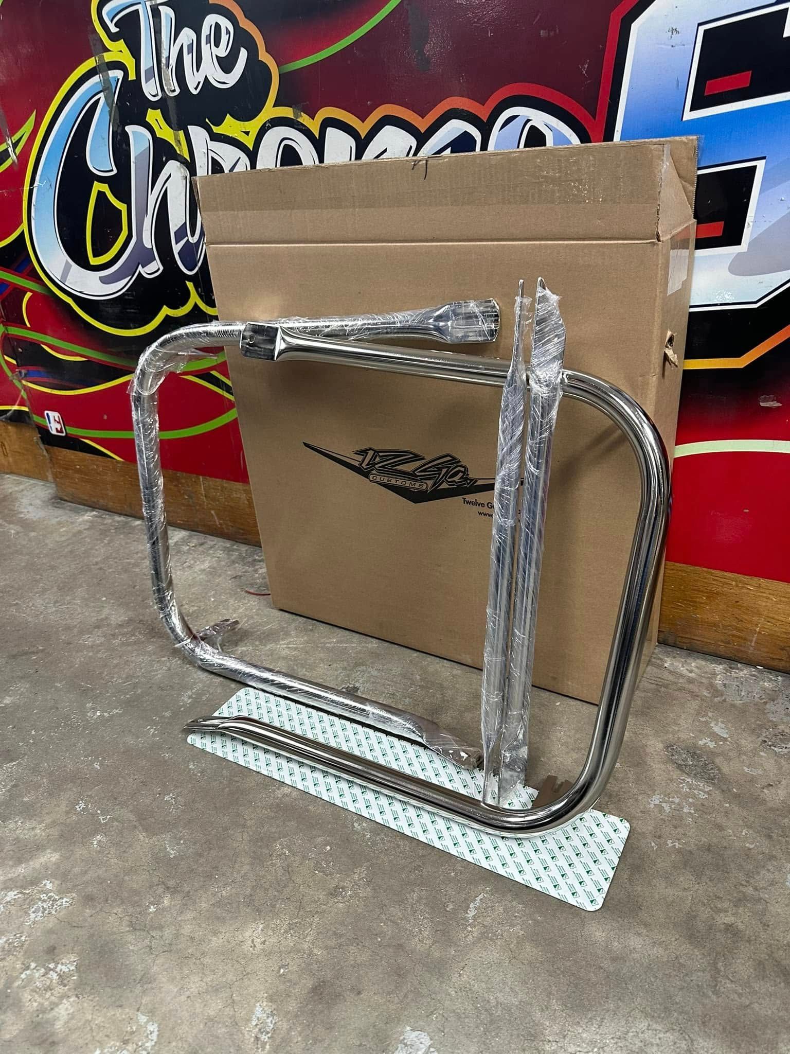 A metal frame is sitting on top of a cardboard box.