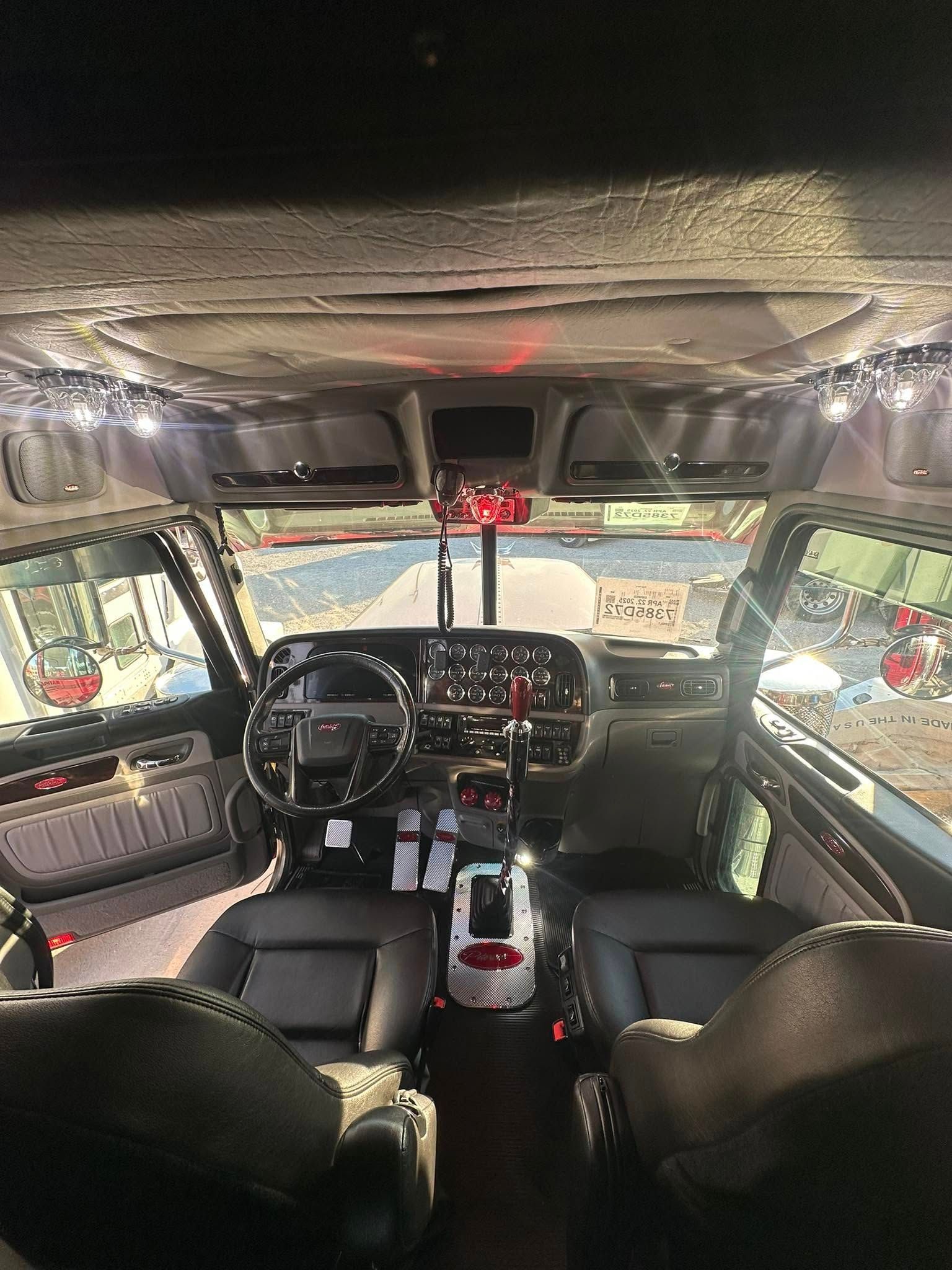 The interior of a car with christmas lights on the ceiling.