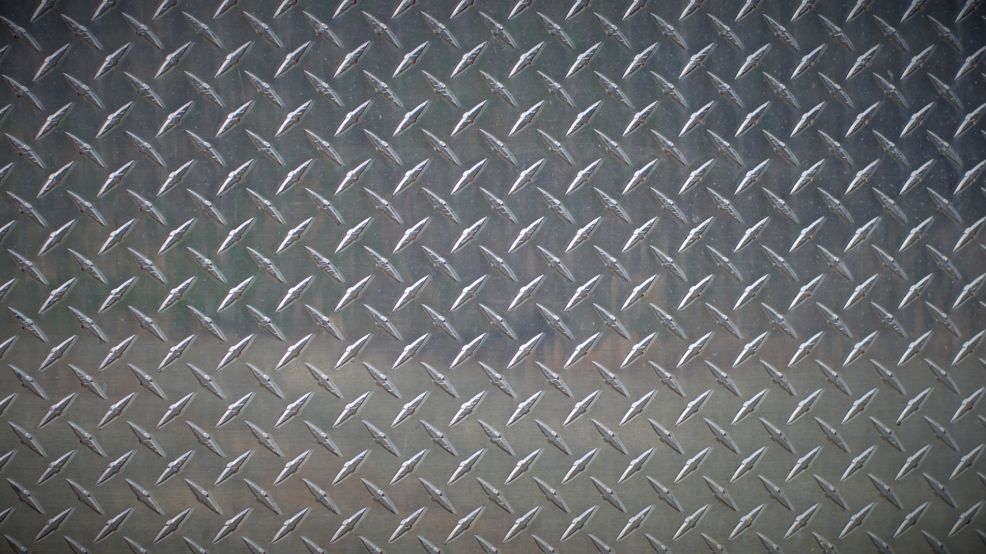 A close up of a metal surface with a diamond pattern.