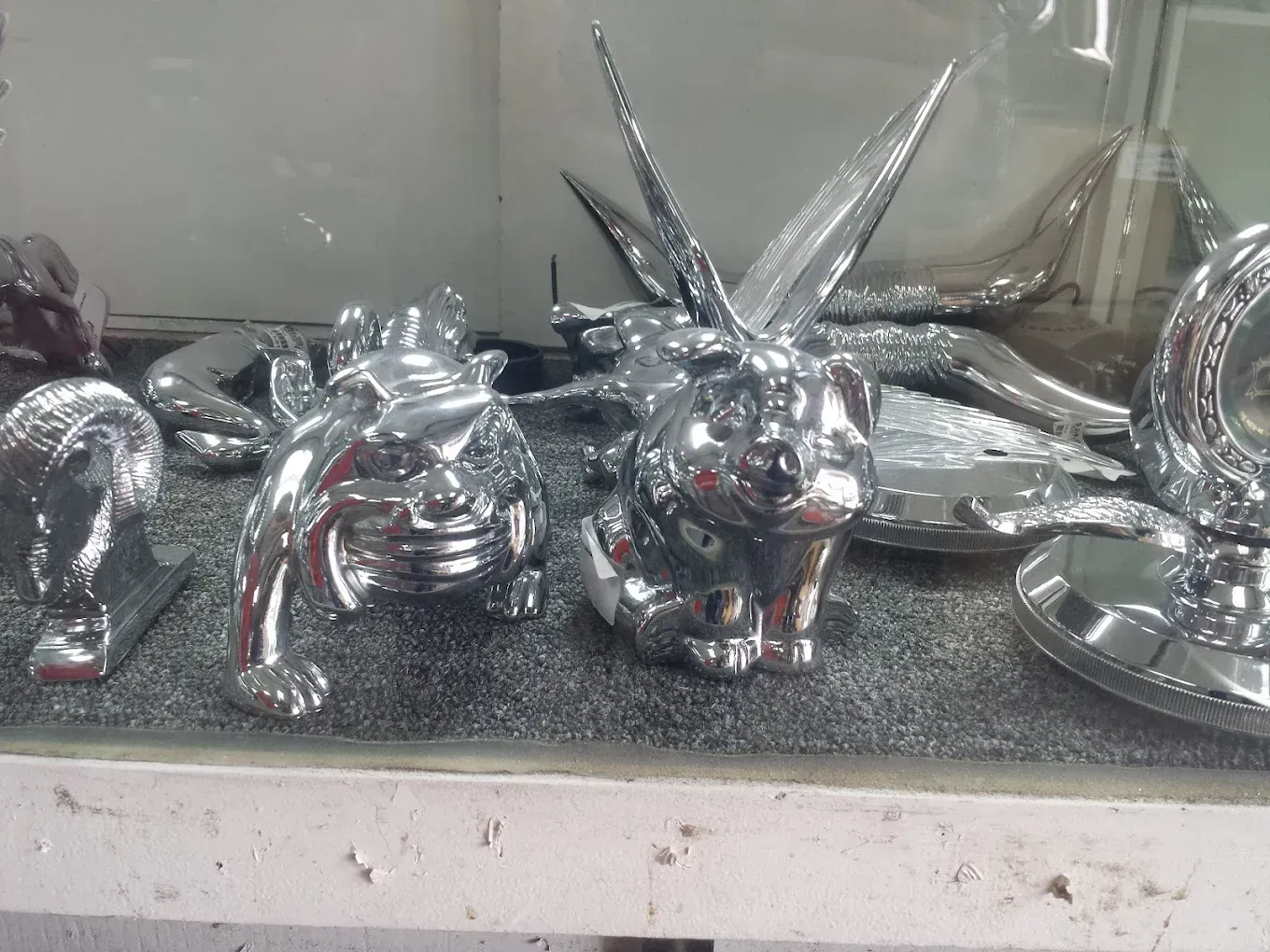 A bunch of chrome animals are sitting on a table