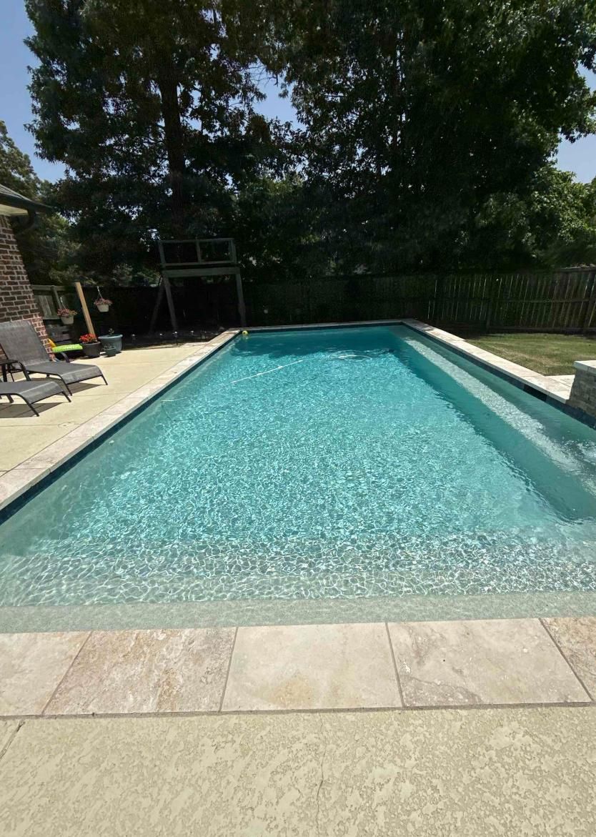 A large swimming pool filled with green water in a backyard.