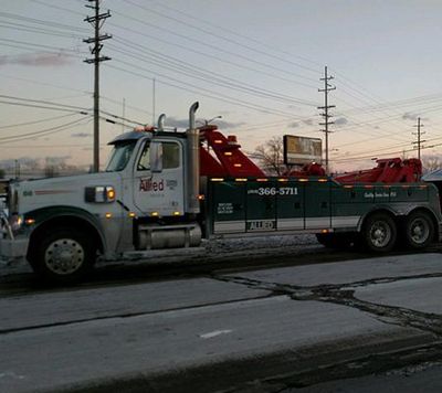 Our commercial truck towing services being performed in Detroit, MI” title=“Commercial Towing — Towing Truck on the Road in Detroit, MI