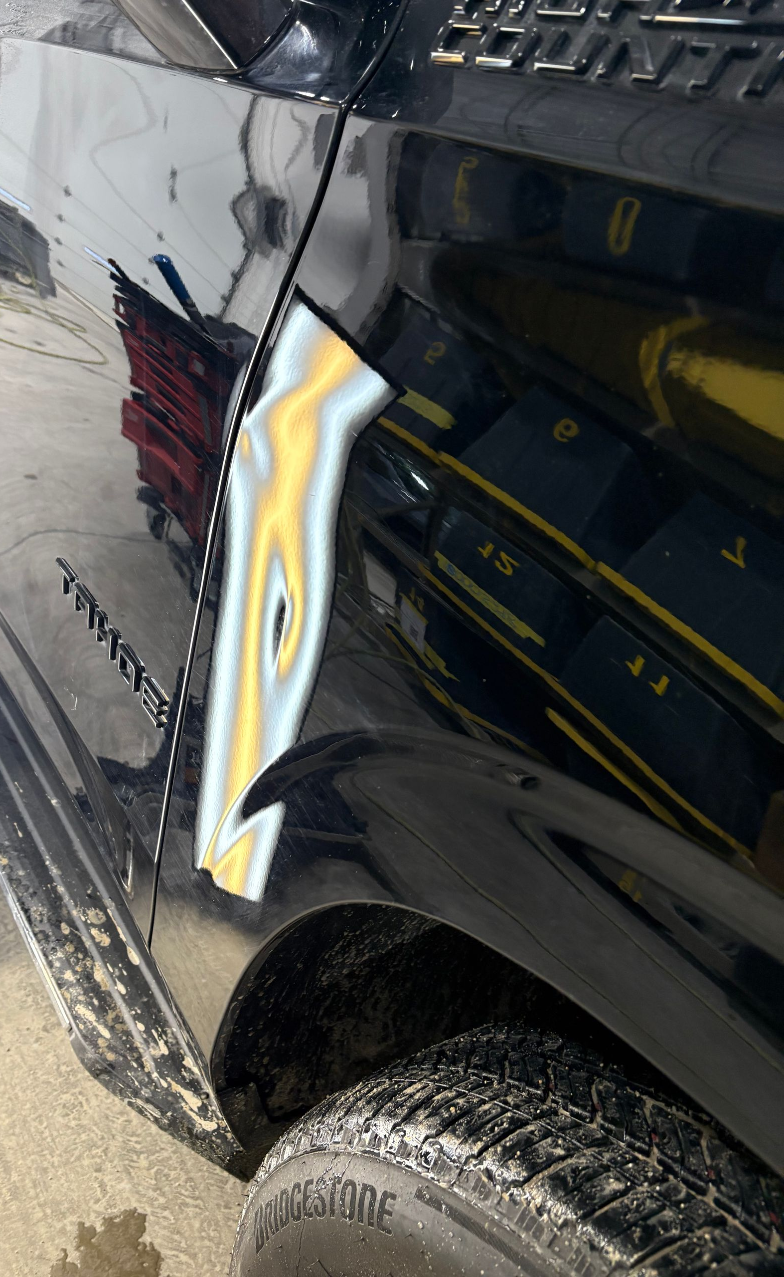 2024 Chevy Tahoe body-line crease dent before paintless dent repair in Highland Indiana  