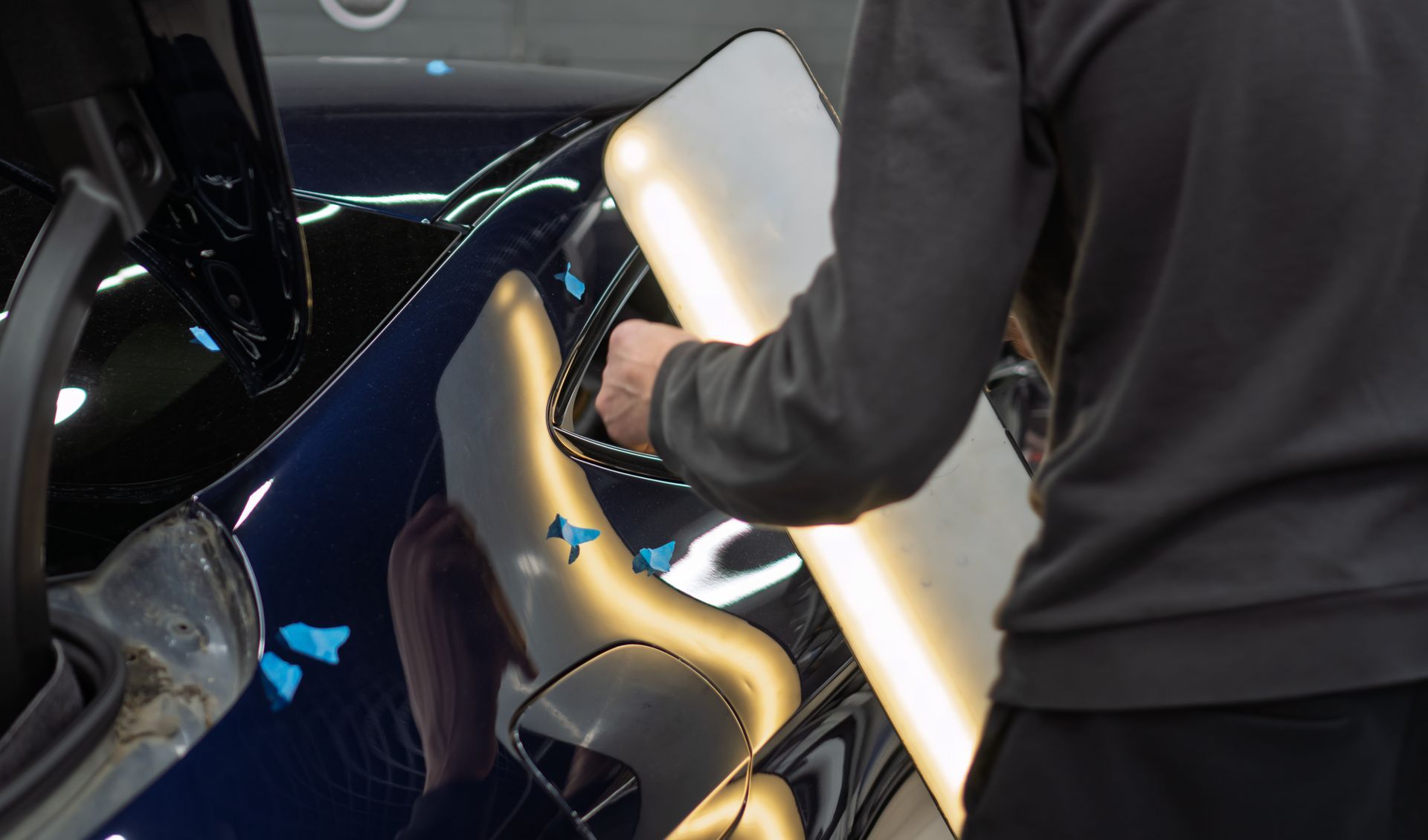 Process of paintless dent repair on a car body.