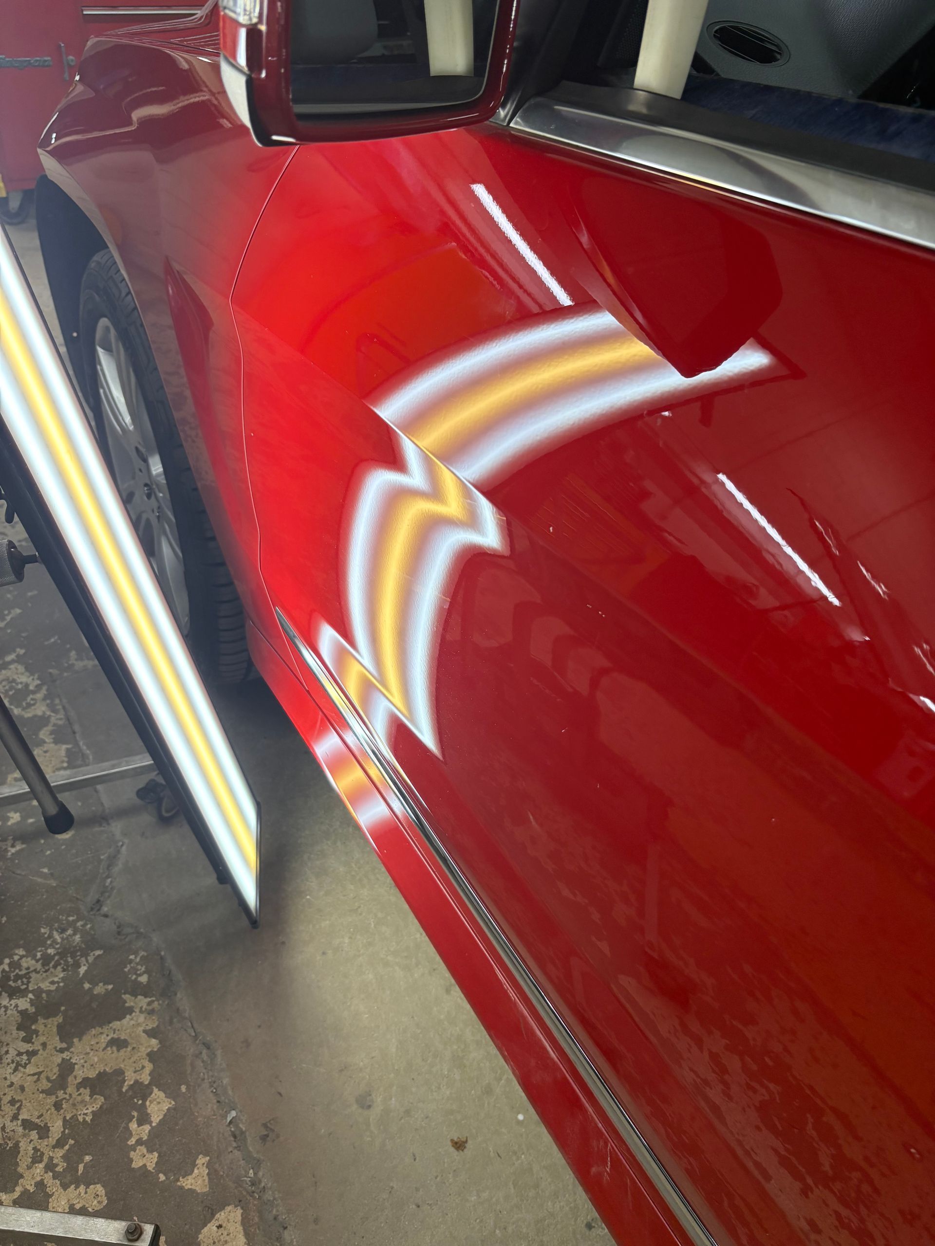 Severe body-line crease dent before paintless dent repair  