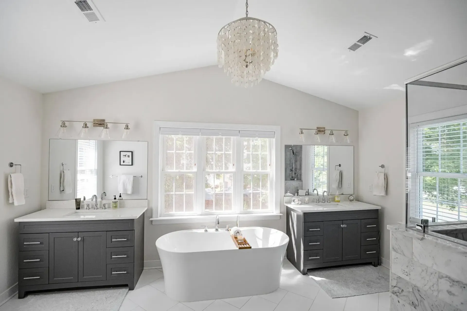 General Contractor in Richmond, VA: A bathroom with two sinks , a tub , and a chandelier.