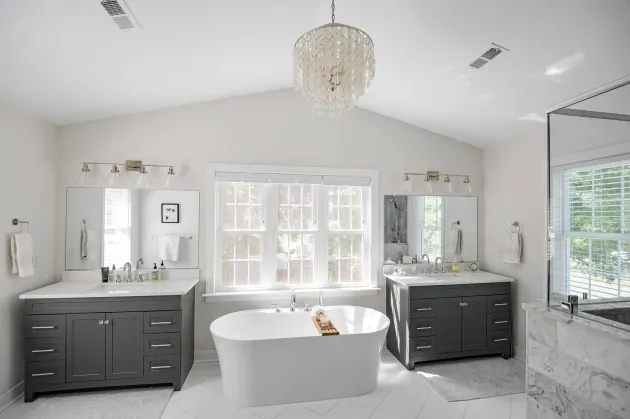 General Contractor in Richmond, VA: A bathroom with two sinks , a tub , and a chandelier.
