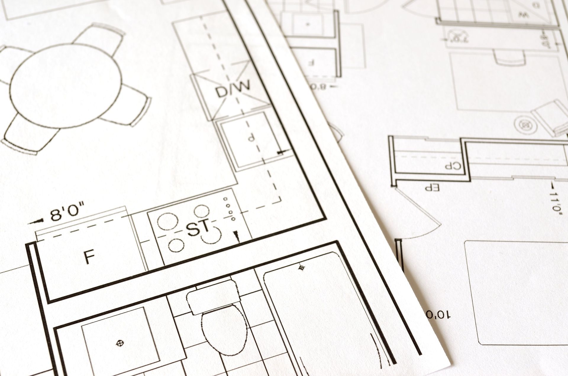 Home Additions: Architectural floor plan drawings with room labels and measurements on white paper.
