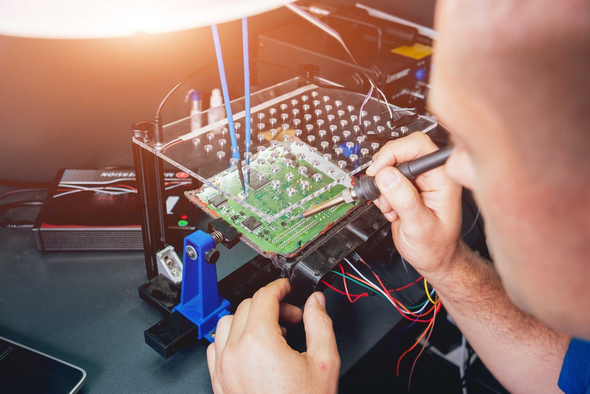 Person lifting a window air conditioner unit on a rooftop.
