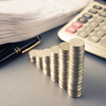 Coins heap stair as growing graph symbol on finance working desk