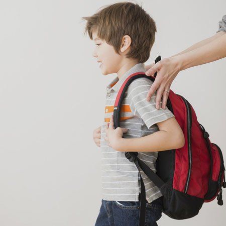 Hispanic mother rushing son to school