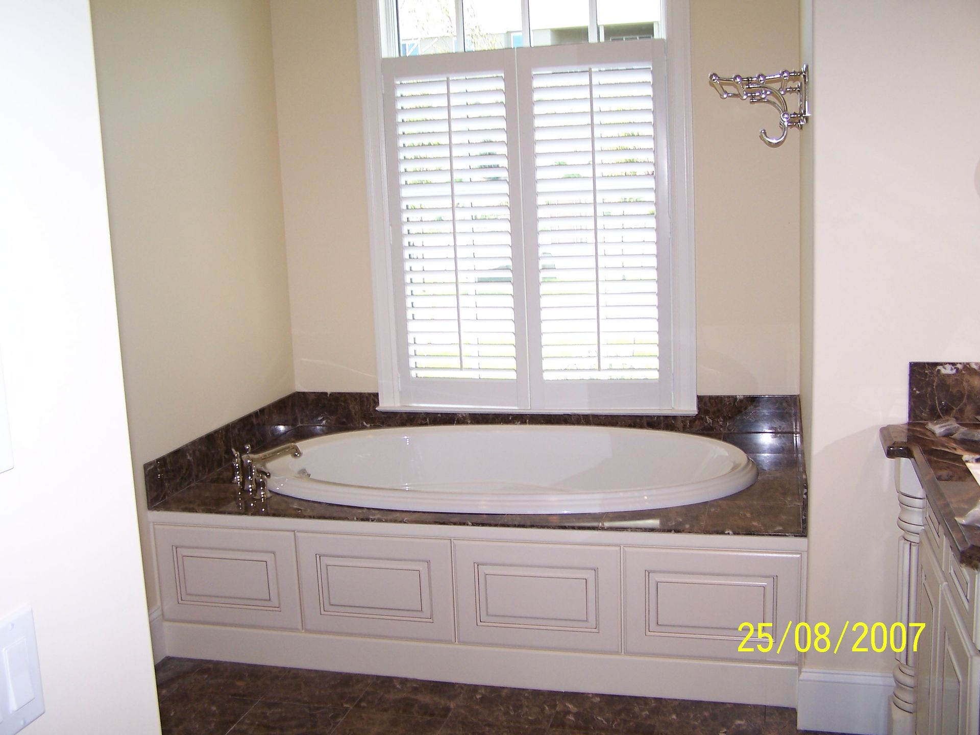A bathroom with a jacuzzi tub and a window