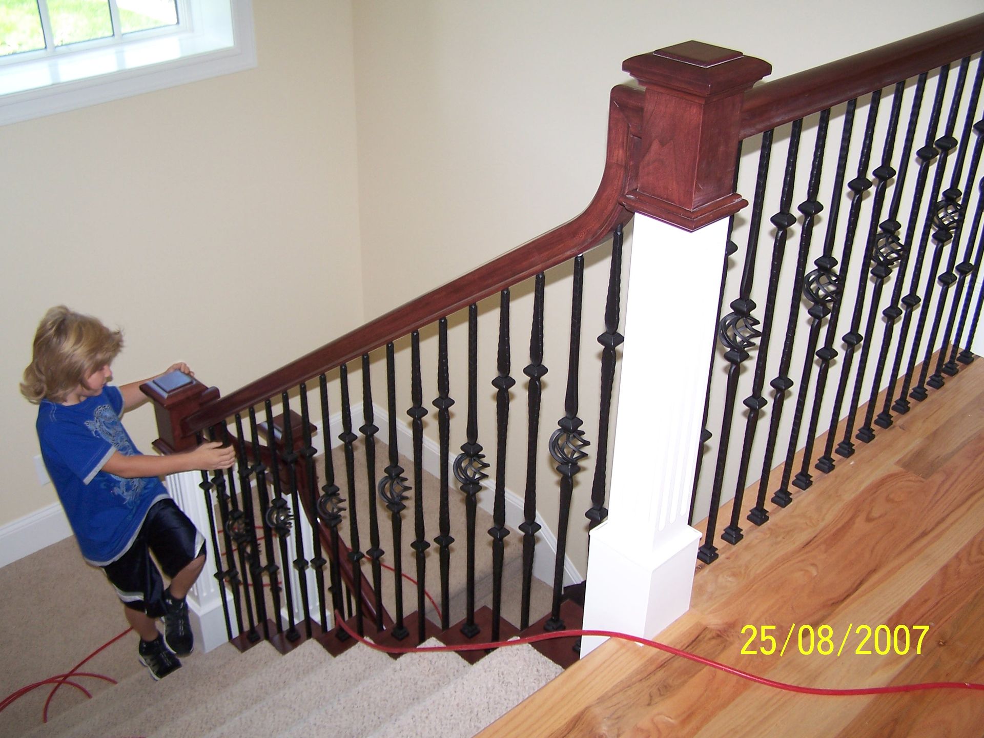 A young boy is climbing up a set of stairs in a photo dated 25/08/2007