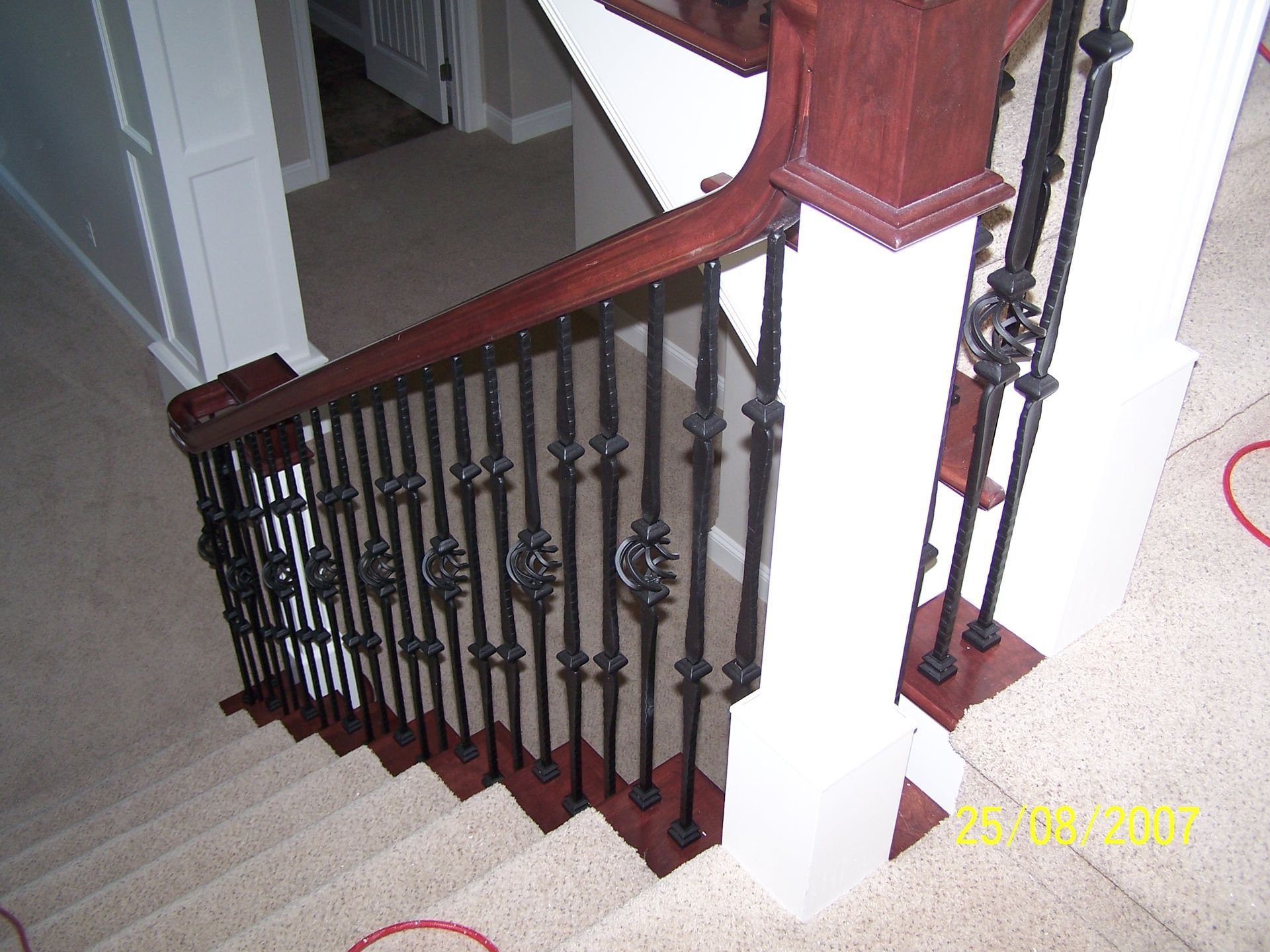 An aerial view of a staircase with a wrought iron railing