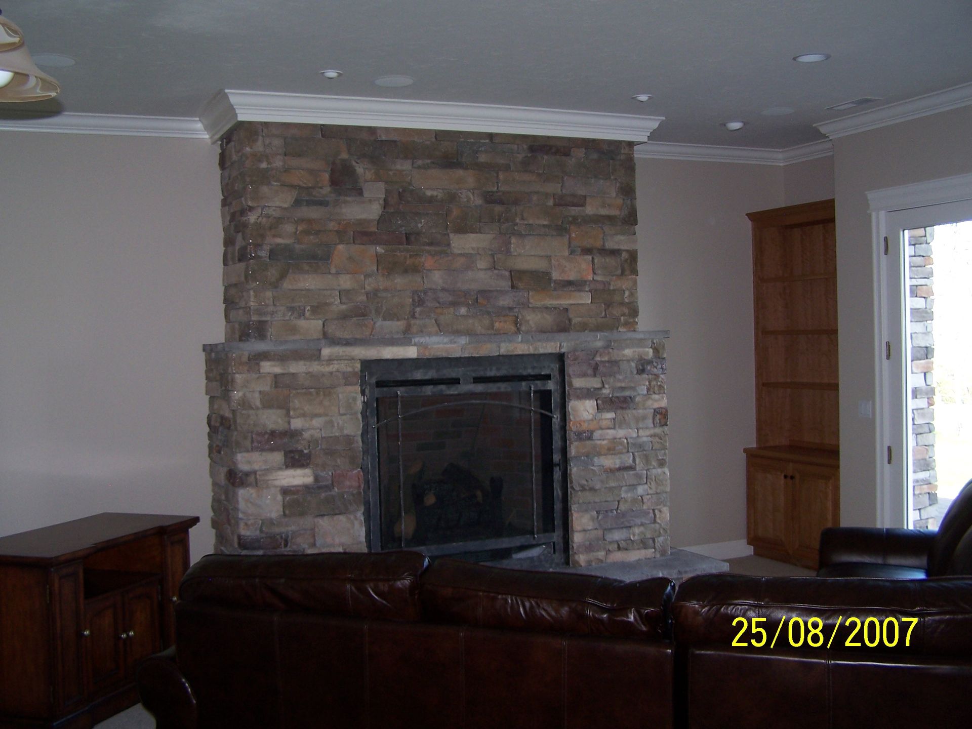 A picture of a living room with a fireplace taken on august 25 2007