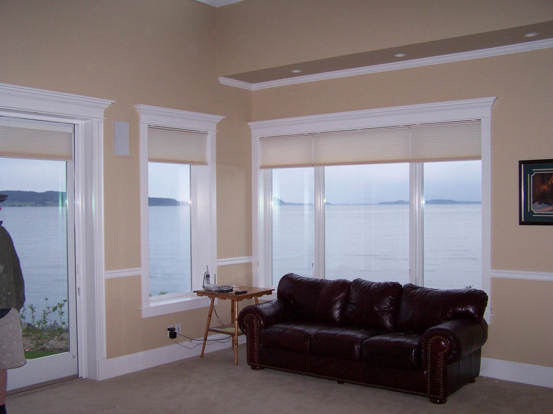 A living room with a couch and a view of the ocean