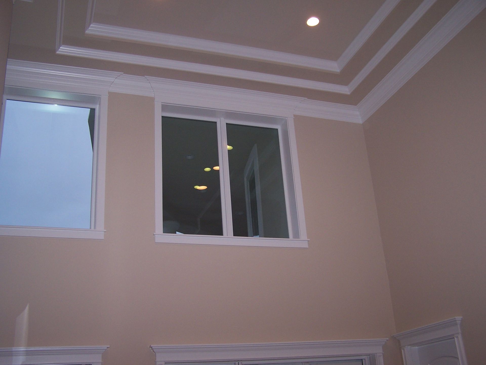 A room with two windows and a ceiling