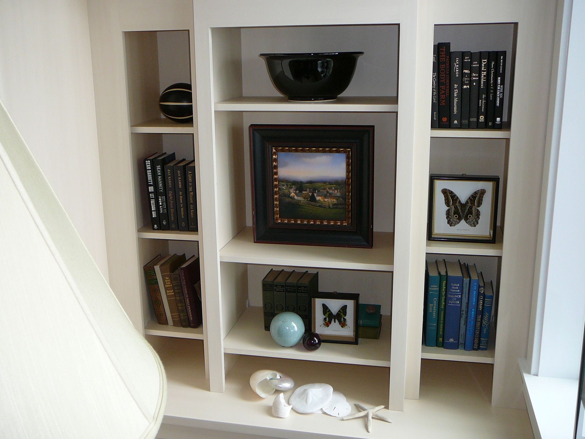 A bookshelf with a picture of a butterfly on it