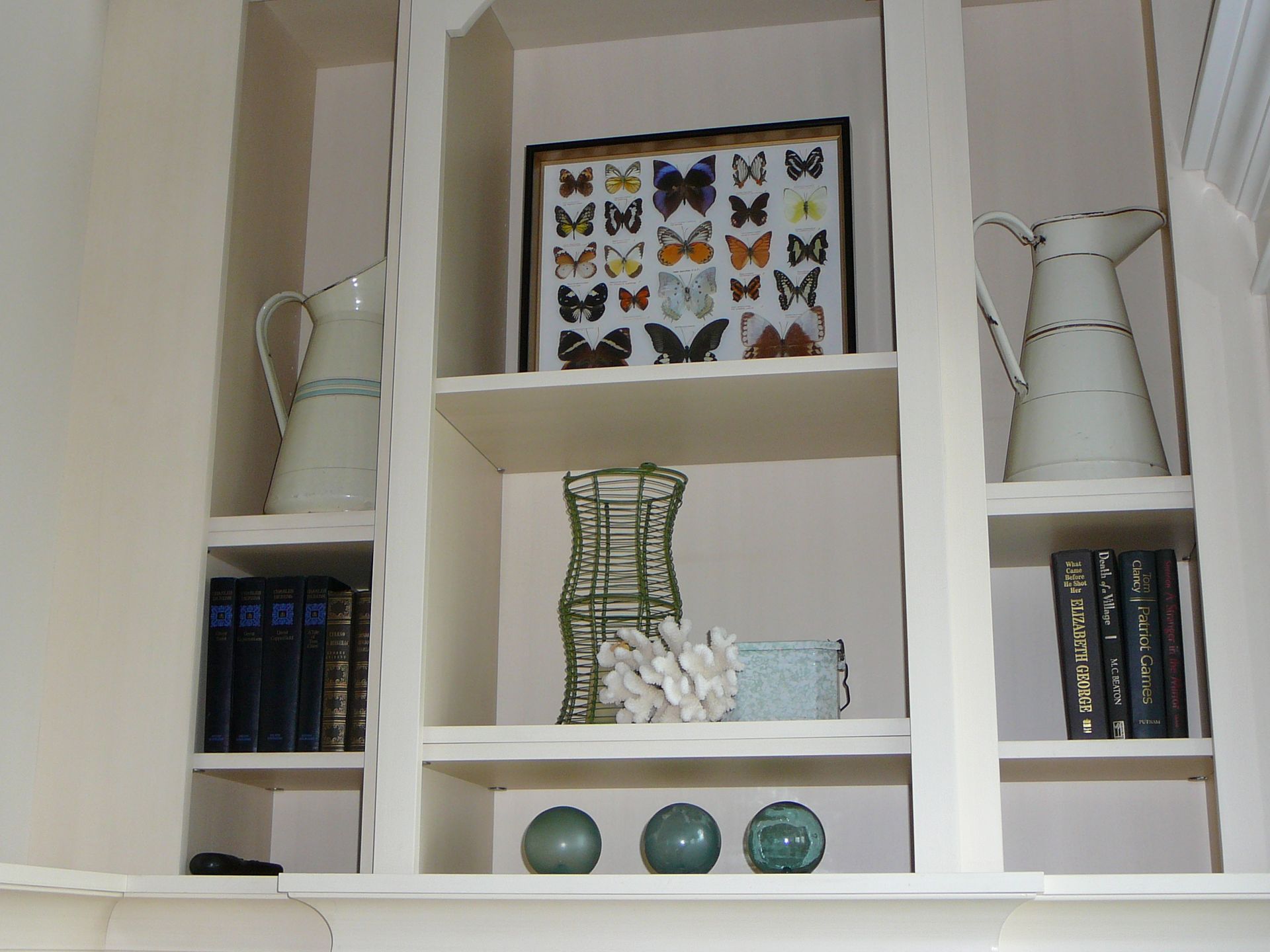 A shelf with a picture of butterflies on it