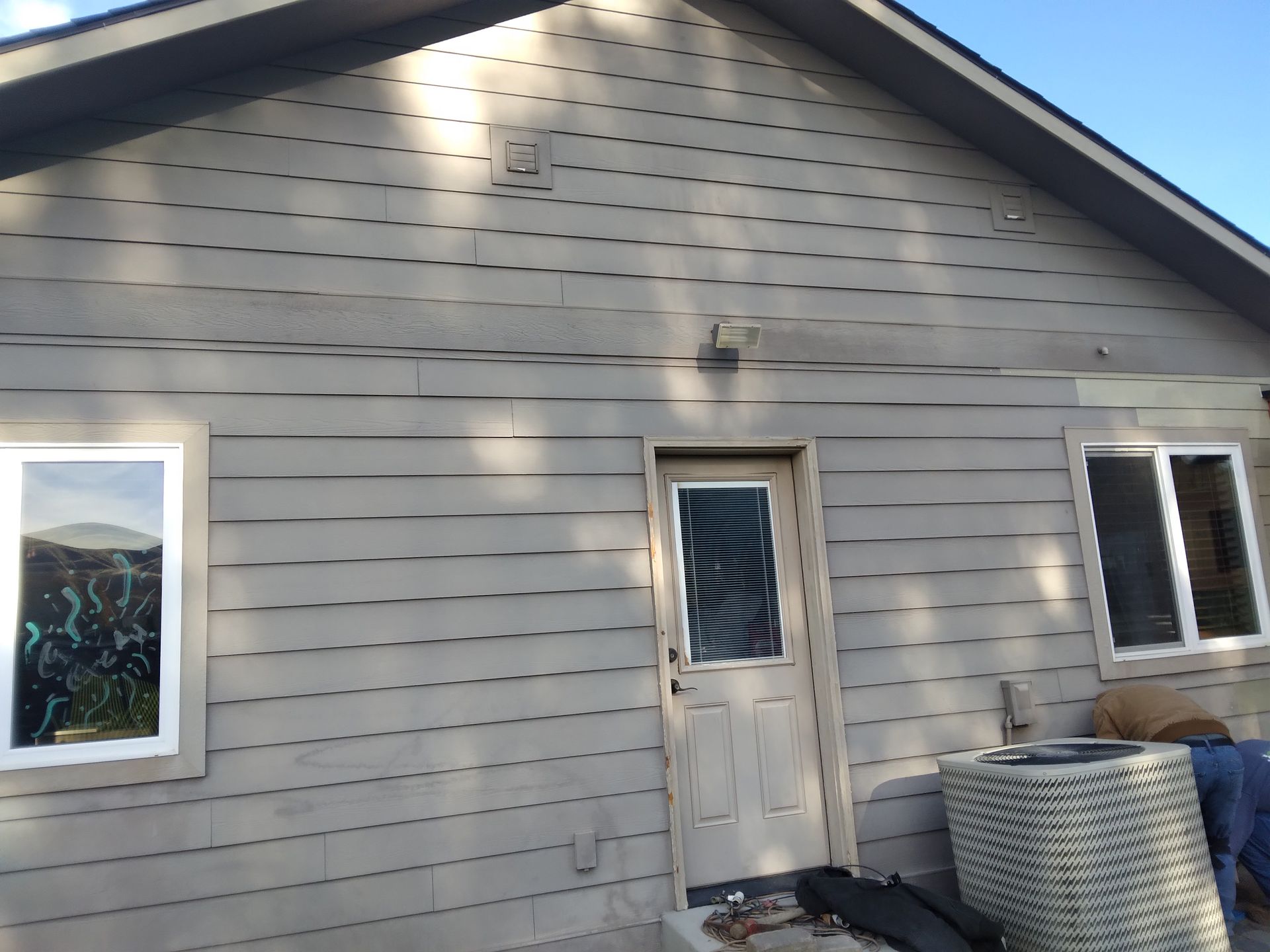 The front of a house with a door and two windows