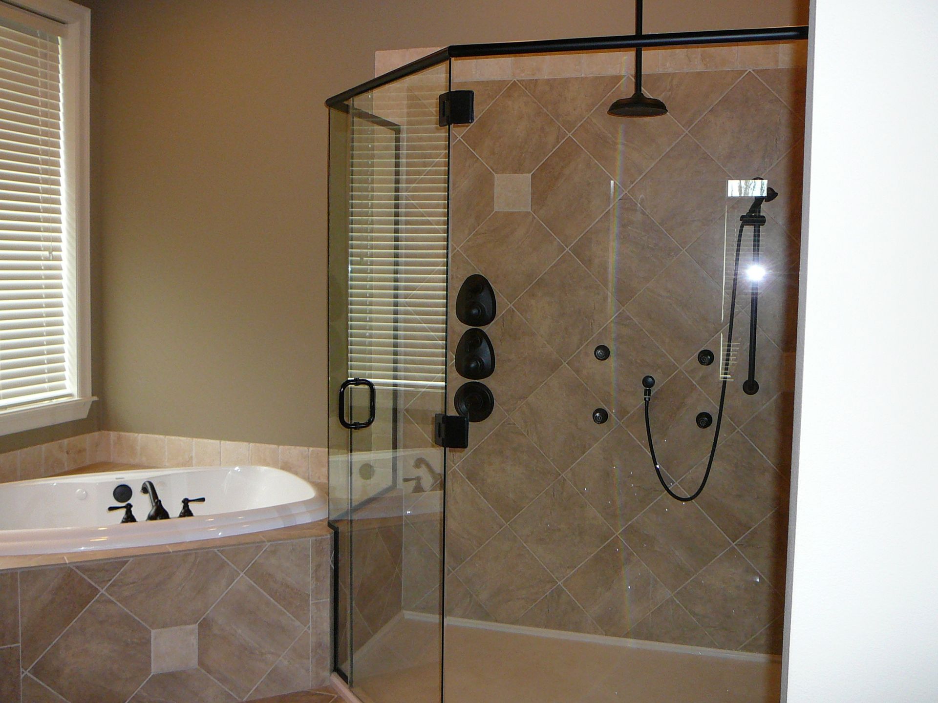 A bathroom with a tub and a walk in shower