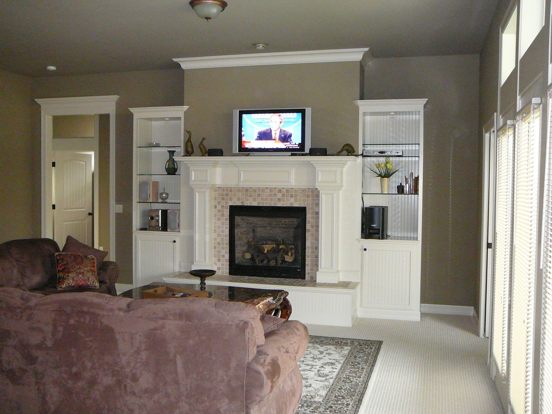 A living room with a fireplace and a flat screen tv