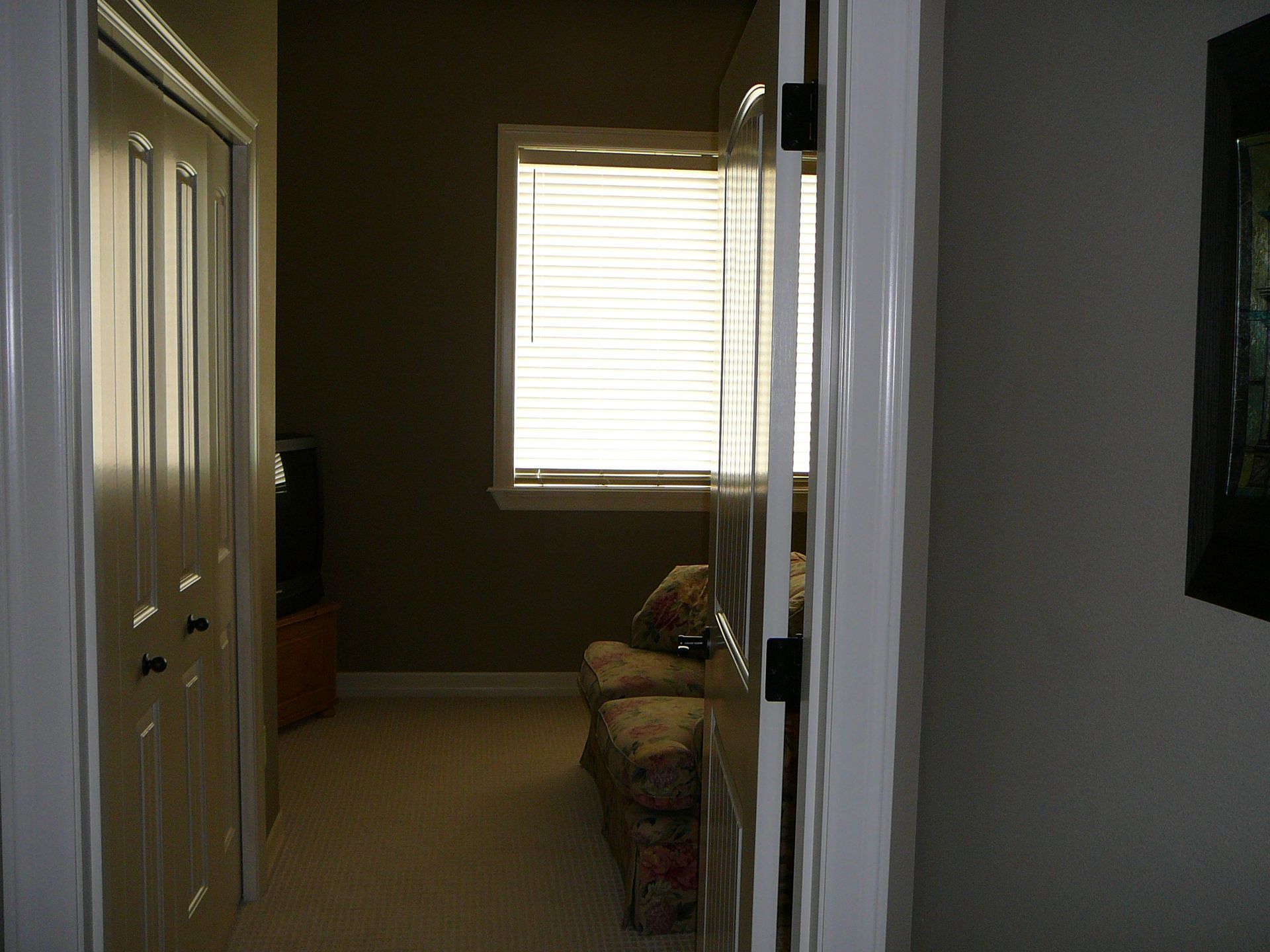 A living room with a couch and a window