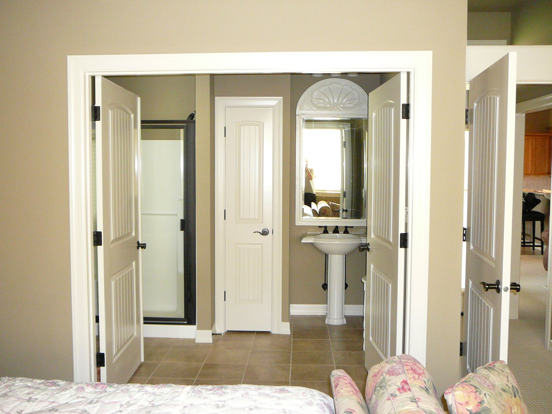 A bathroom with a pedestal sink and a mirror