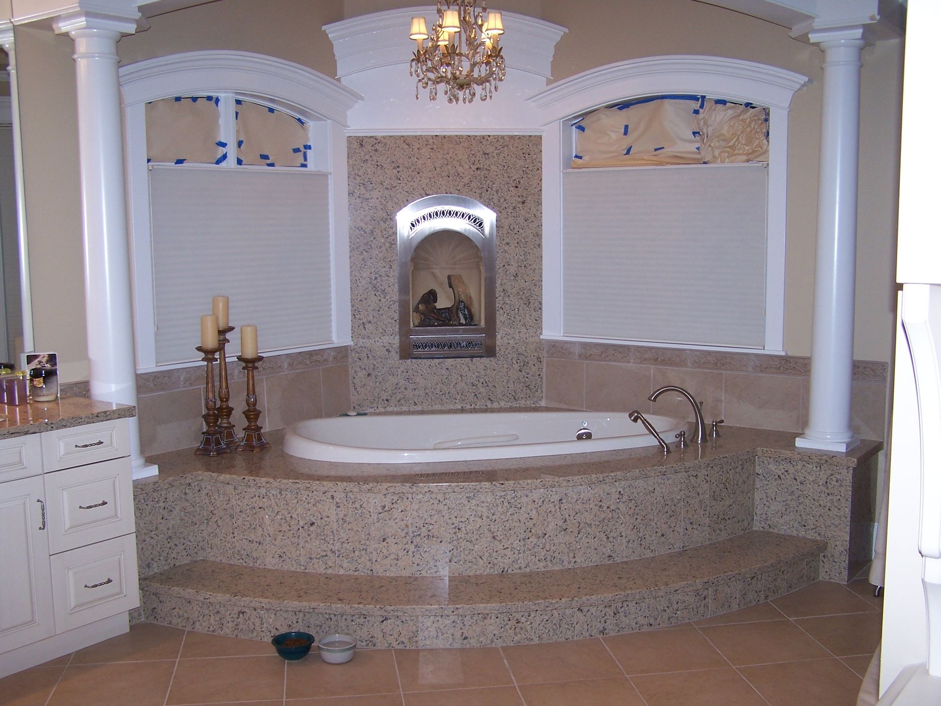 A bathroom with a bathtub and candles on the counter