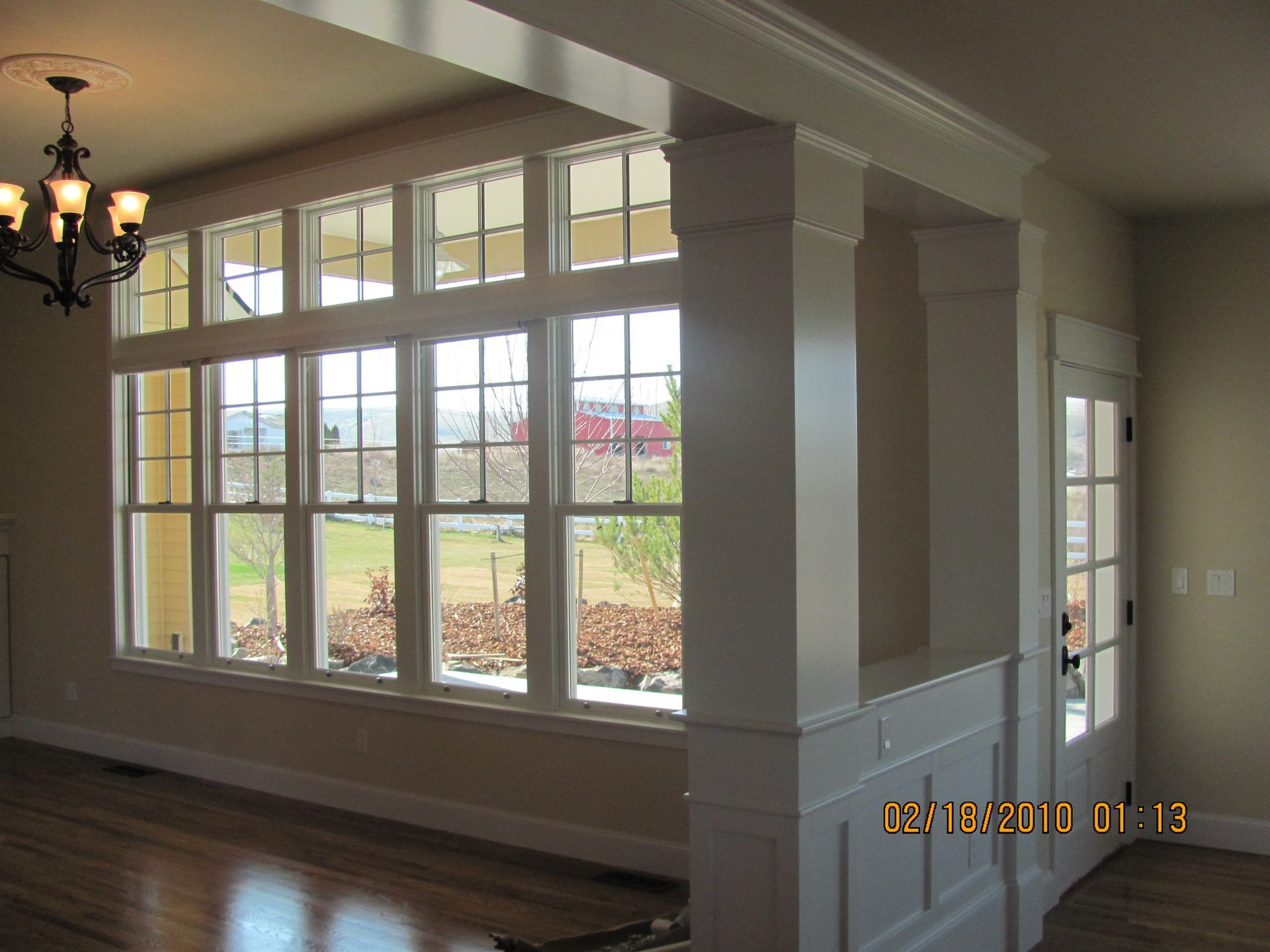 A room with a lot of windows and a chandelier