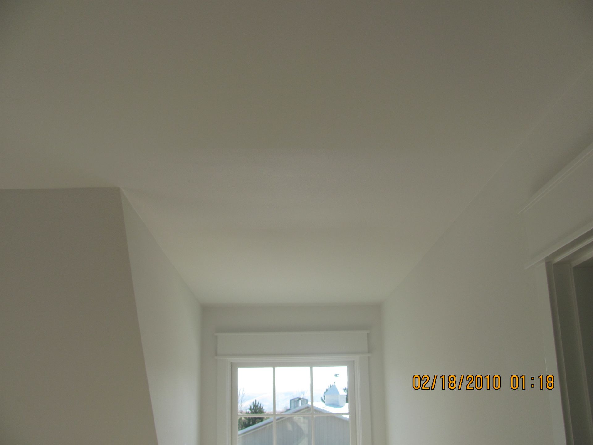 A picture of a hallway with a window taken on february 18 2010