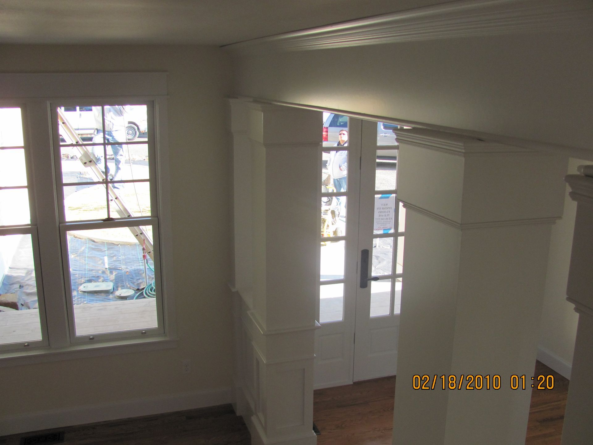 A picture of a room with a window and a door taken on february 18 2010