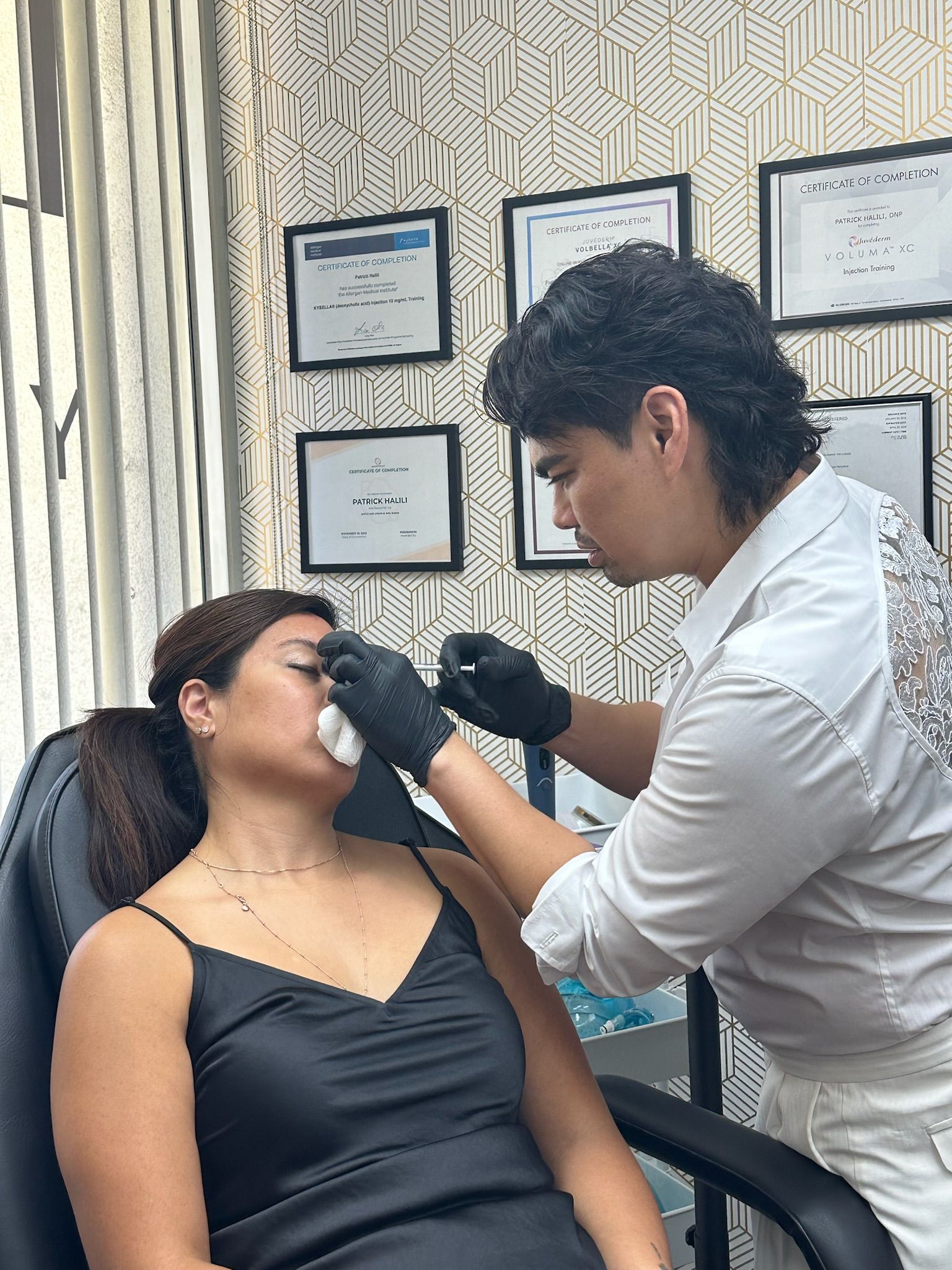 Person getting cosmetic procedure on face by a practitioner in an office.