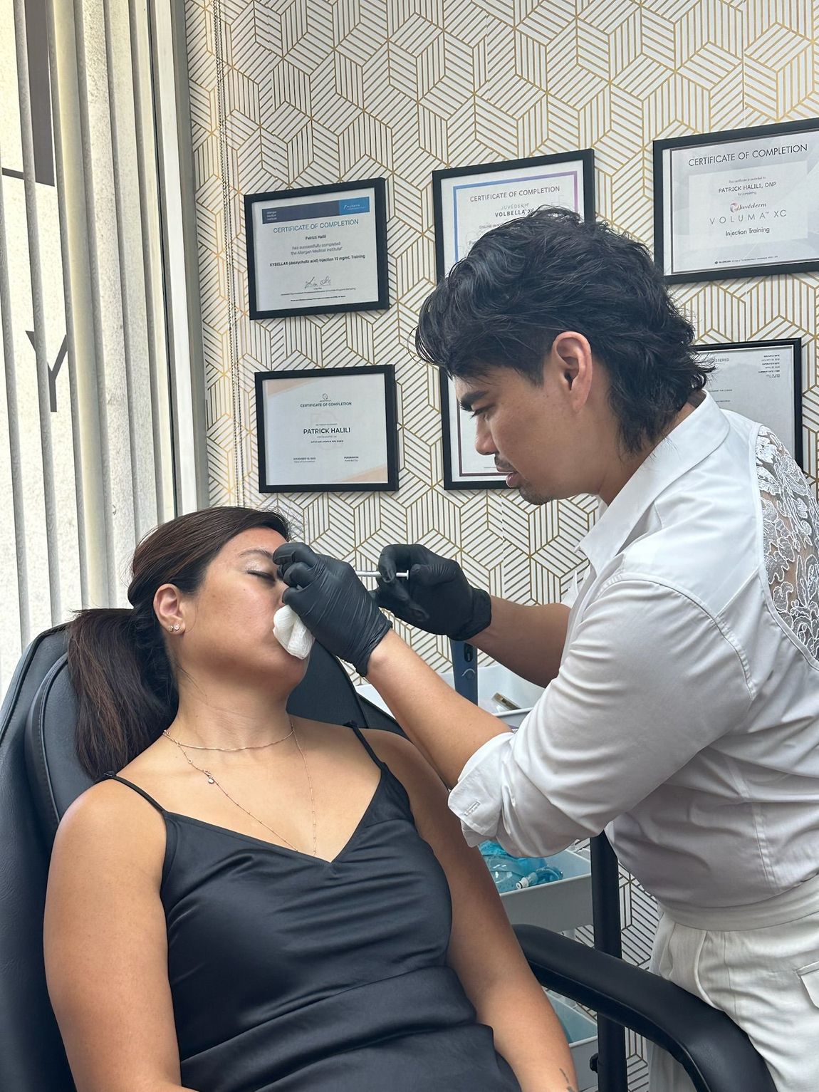 A man is doing skin treatment to a woman