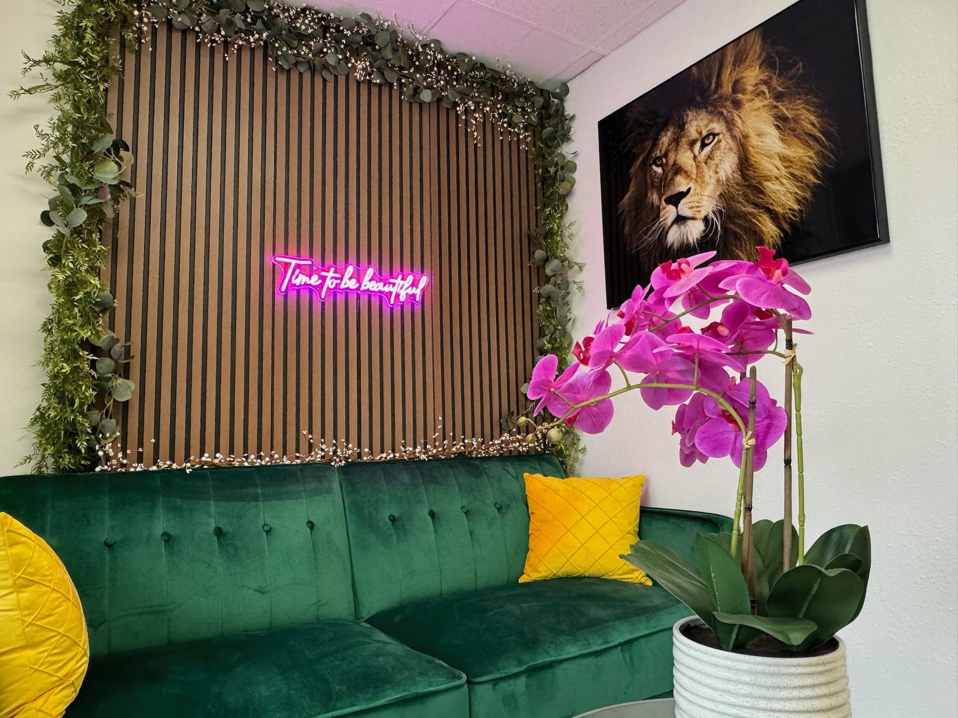 A hallway with a mirror and a black and white striped wall.