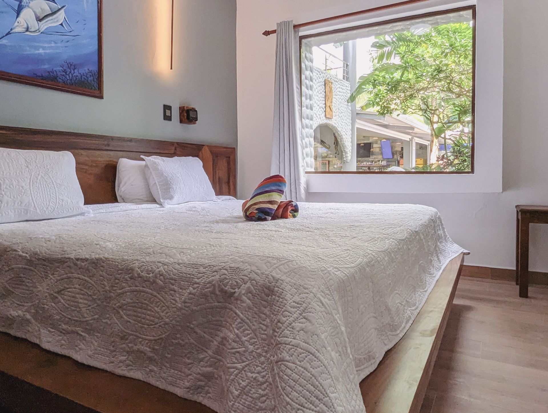 A bedroom with a large bed and a large window.