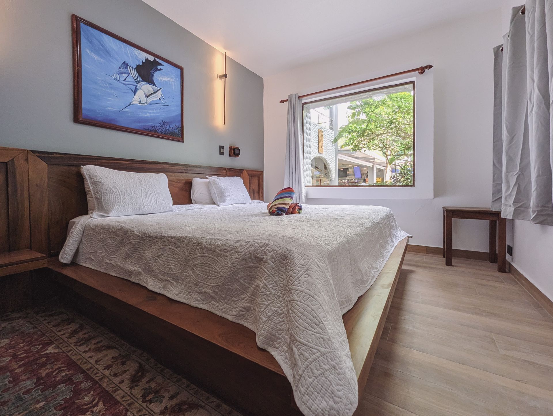 A bedroom with a large bed and a window.