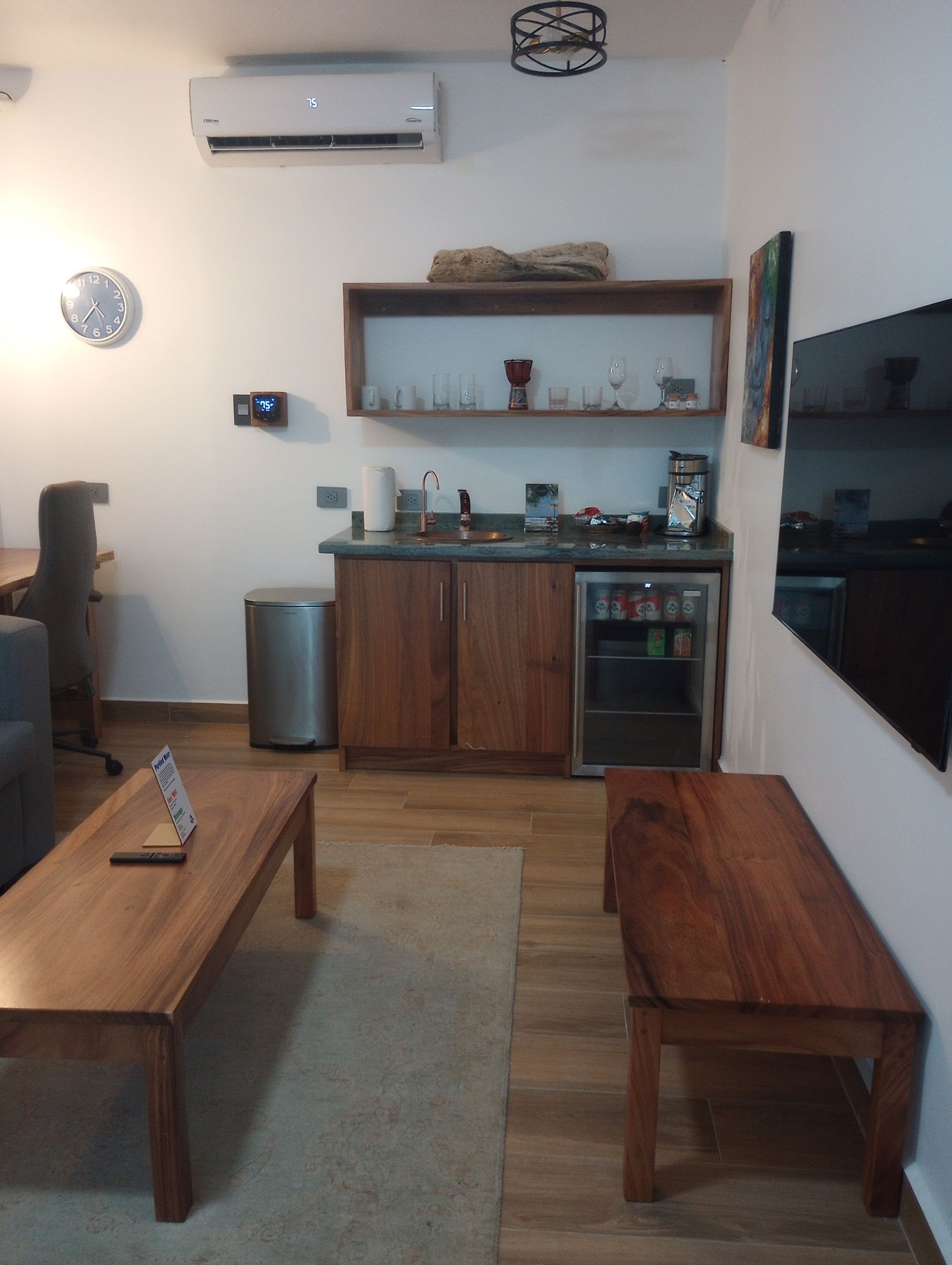 A living room with wooden furniture and a flat screen tv